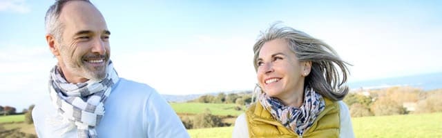 A woman and man smiling at each other.