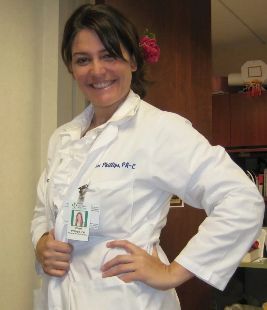 A woman in white lab coat holding her hands on the chest.