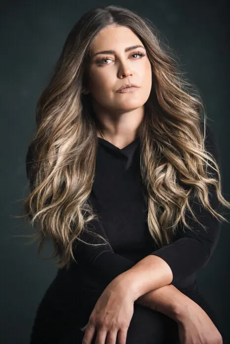 A woman with long hair posing for the camera.